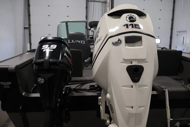 Slide: The Image of 2013 Lund 1750 Tyee boat with dual outboard motors in a garage setting. - 62