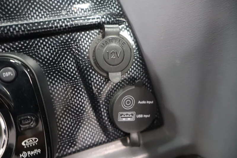 Slide: The Image of 2013 Lund 1750 Tyee dashboard with 12V marine socket and audio/USB inputs. - 25
