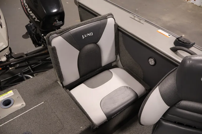 Slide: The Image of 2013 Lund 1750 Tyee boat interior with cushioned seating and Mercury engine. - 41