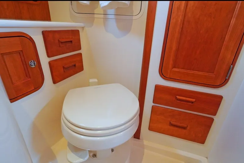 Slide: The Image of Hinckley 35 yacht bathroom with wooden cabinetry and modern toilet, 2022 model. - 19
