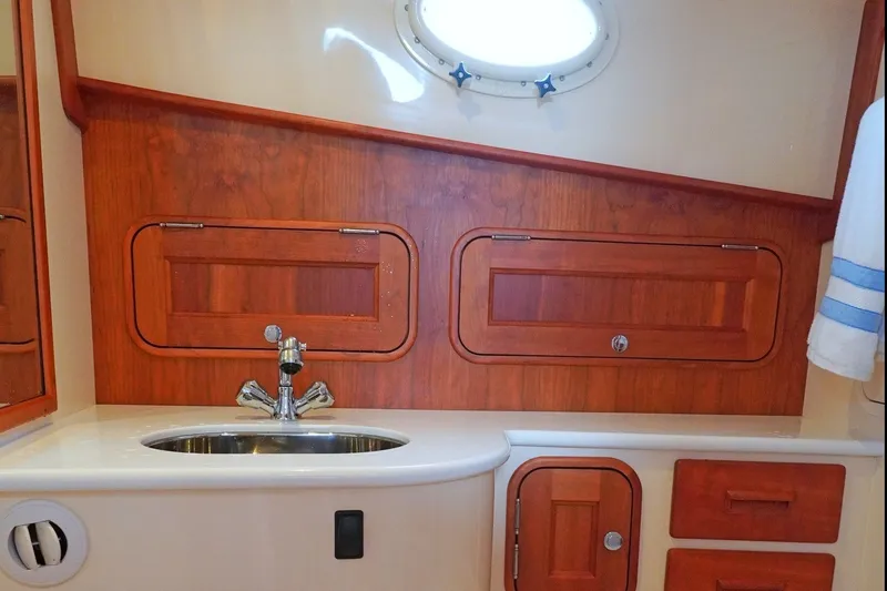 Slide: The Image of Elegant Hinckley 35 yacht interior with wooden cabinetry and sink, 2022 model. - 17