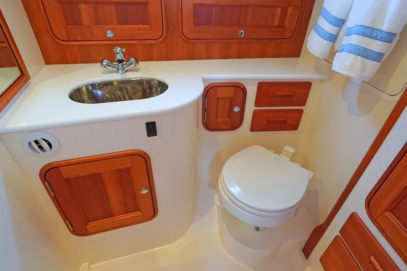 Slide: The Image of Hinckley 35 yacht bathroom, 2022 model, featuring wooden cabinetry and modern fixtures. - 18
