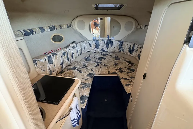 Slide: The Image of Interior cabin of a 2000 Sea Ray 245 Weekender boat with patterned seating. - 15