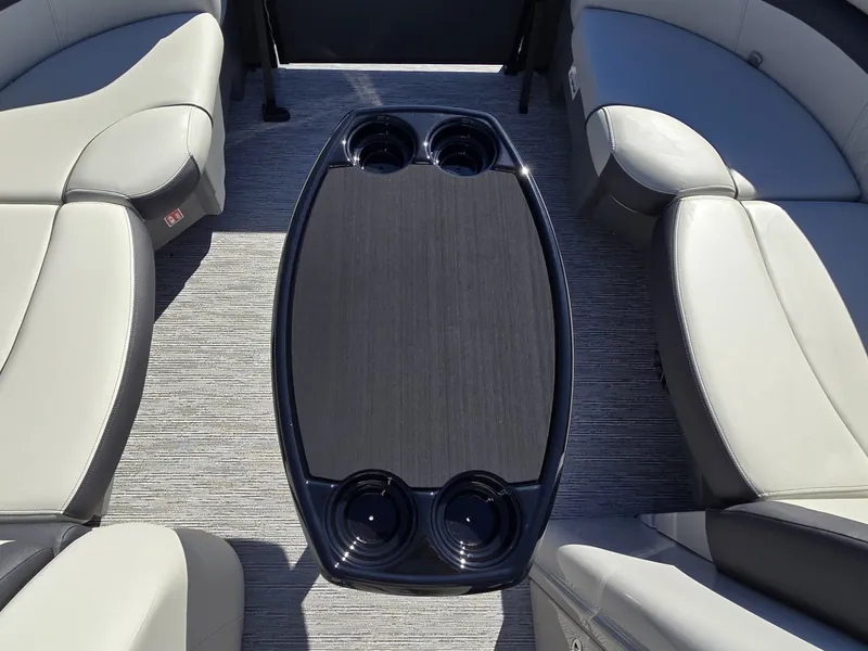 Slide: The Image of Interior of a 2027 Starcraft EX 20 Q DH with gray seating and a table with cup holders. - 24