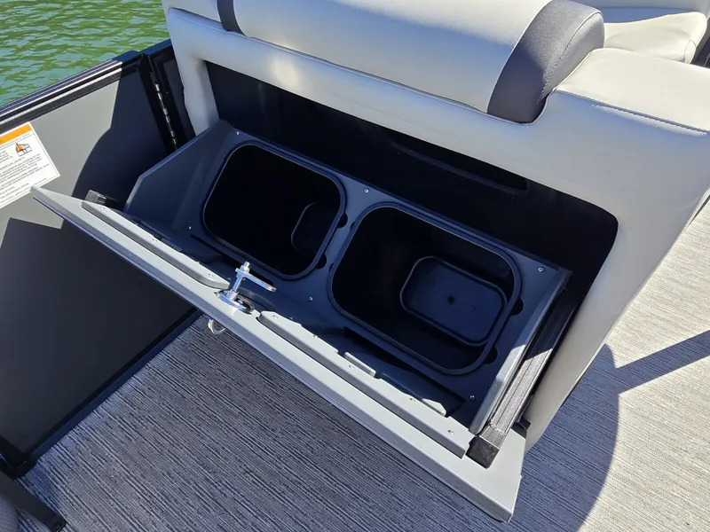 Slide: The Image of The image shows a storage compartment with two black bins on a boat. - 17