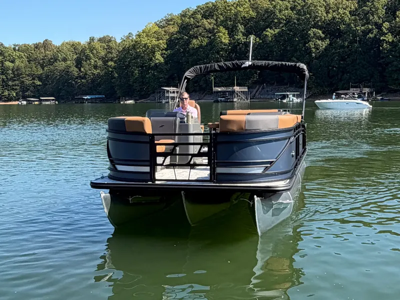 Slide: The Image of A 2027 Starcraft EXS 3 DL pontoon boat on a calm lake. - 39