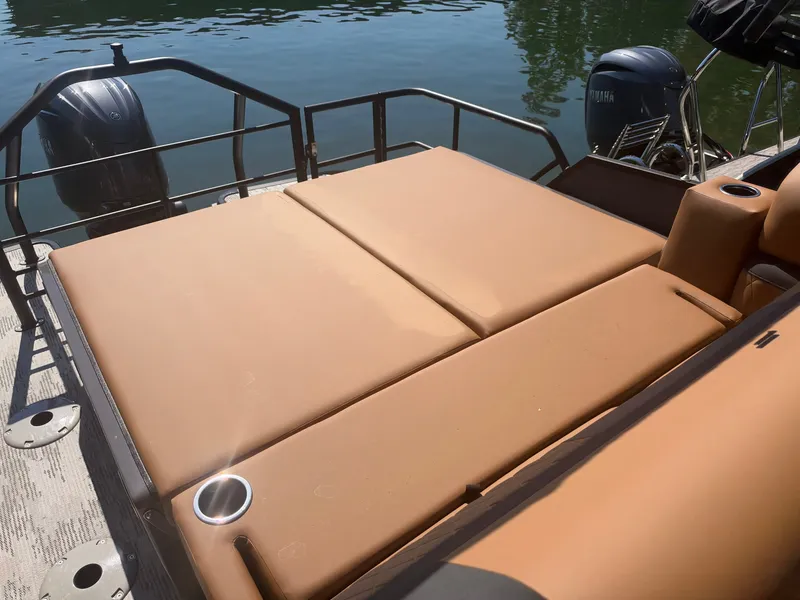 Slide: The Image of The image shows the lounge pad of a 2027 Starcraft EXS 3 DL boat. - 10