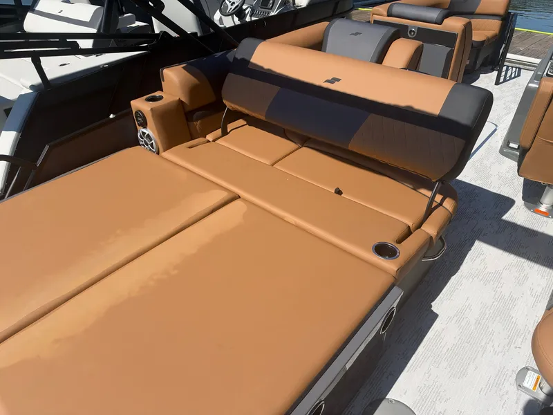 Slide: The Image of The image shows the lounging area of a 2027 Starcraft EXS 3 DL with brown upholstery. - 9