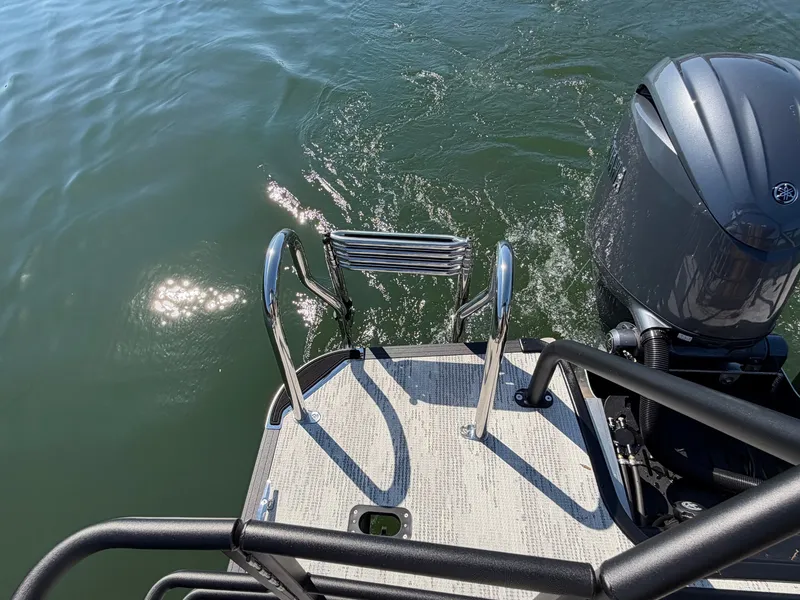 Slide: The Image of A swim platform with a ladder and motor on a boat in the water. - 7
