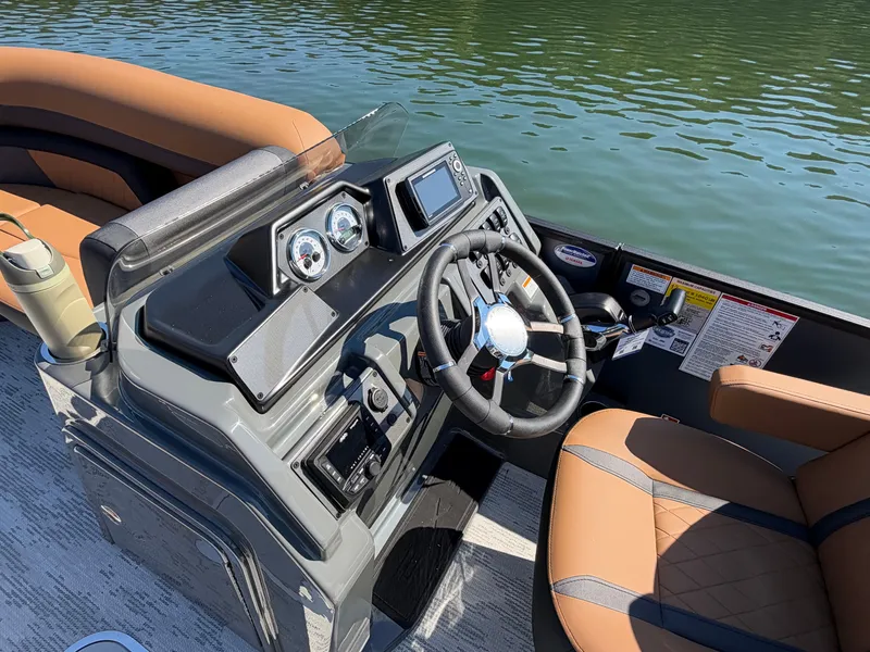 Slide: The Image of The image shows the cockpit of a 2027 Starcraft EXS 3 DL with brown seats. - 25