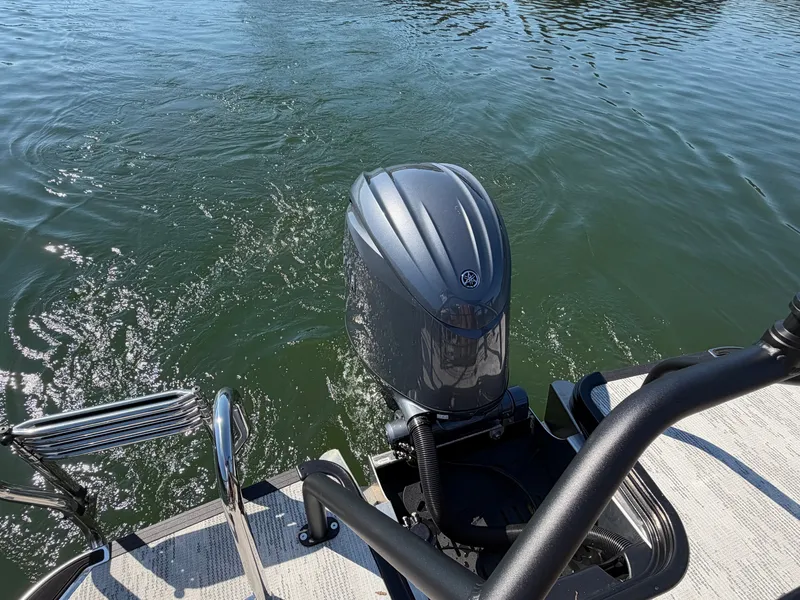 Slide: The Image of An outboard motor on a boat in calm water, with a ladder and railing visible. - 6