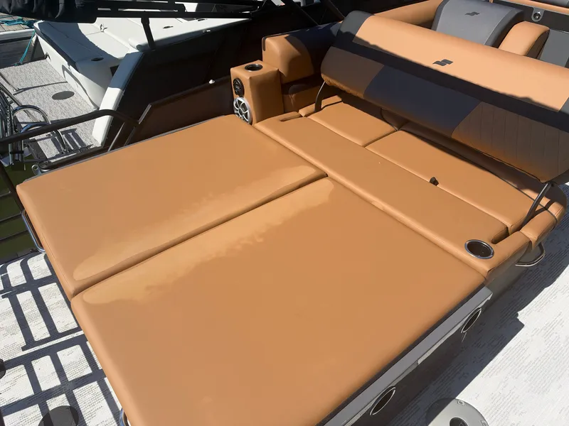 Slide: The Image of The image shows a luxurious sunbed on a boat with brown upholstery. - 31