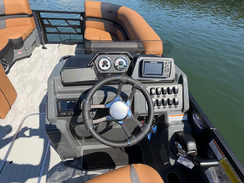 Slide: The Image of The image shows the helm of a 2027 Starcraft EXS 3 DL with modern instruments. - 26