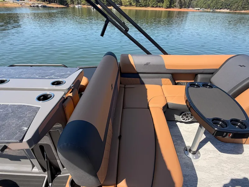 Slide: The Image of The image shows the interior of a 2027 Starcraft EXS 3 DL boat with beige and black seating. - 16