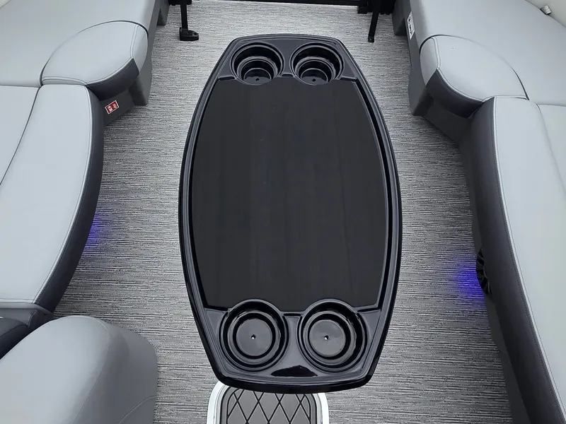 Slide: The Image of A sleek table with cup holders in a modern boat with gray seating. - 25