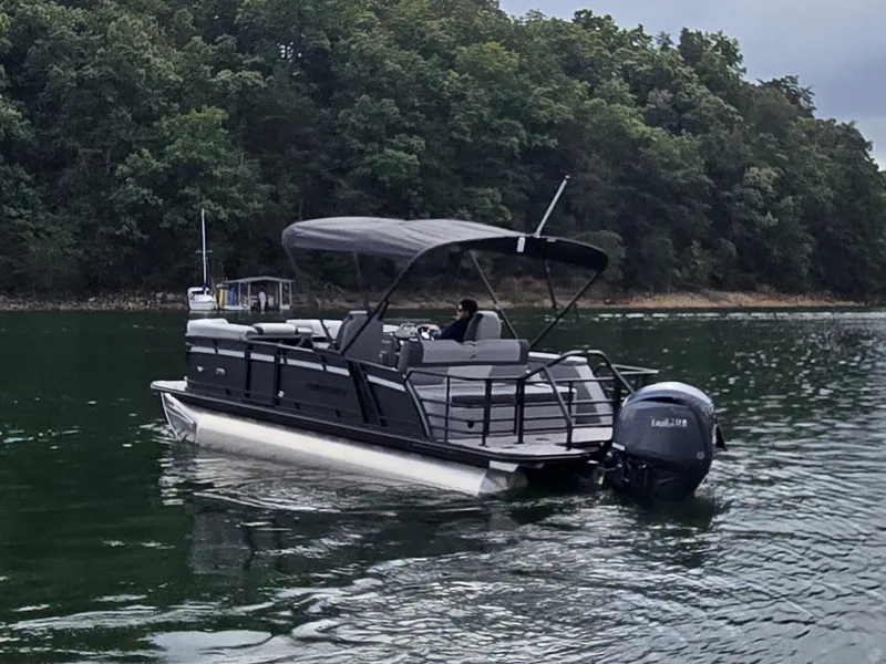 Slide: The Image of A 2027 Starcraft EXS 3 Q DH pontoon boat on a calm lake. - 36