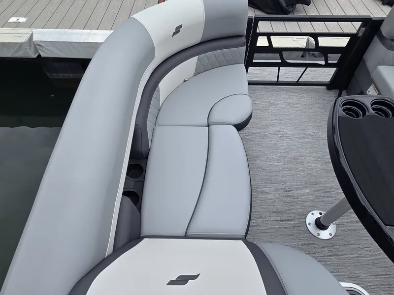 Slide: The Image of The image shows the seating area of a 2027 Starcraft EXS 3 Q DH with gray upholstery. - 24