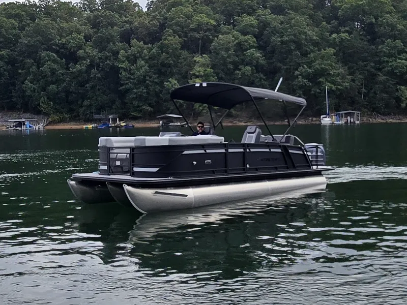 Slide: The Image of A 2027 Starcraft EXS 3 Q DH pontoon boat on a calm lake. - 32