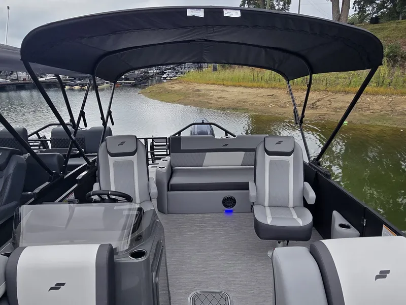 Slide: The Image of The image shows a 2027 Starcraft EXS 3 Q DH boat with gray seating and a black canopy. - 30