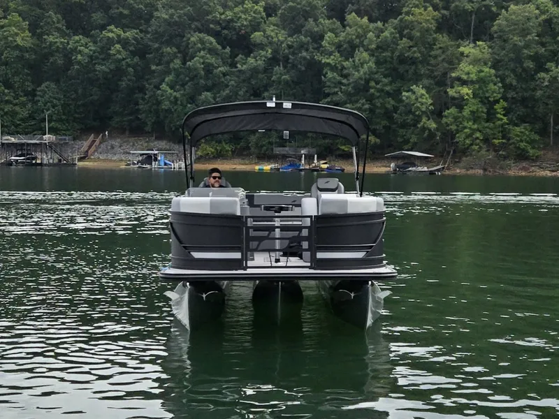 Slide: The Image of Starcraft EXS 3 Q DH 2027 on a calm lake with a wooded shoreline. - 43