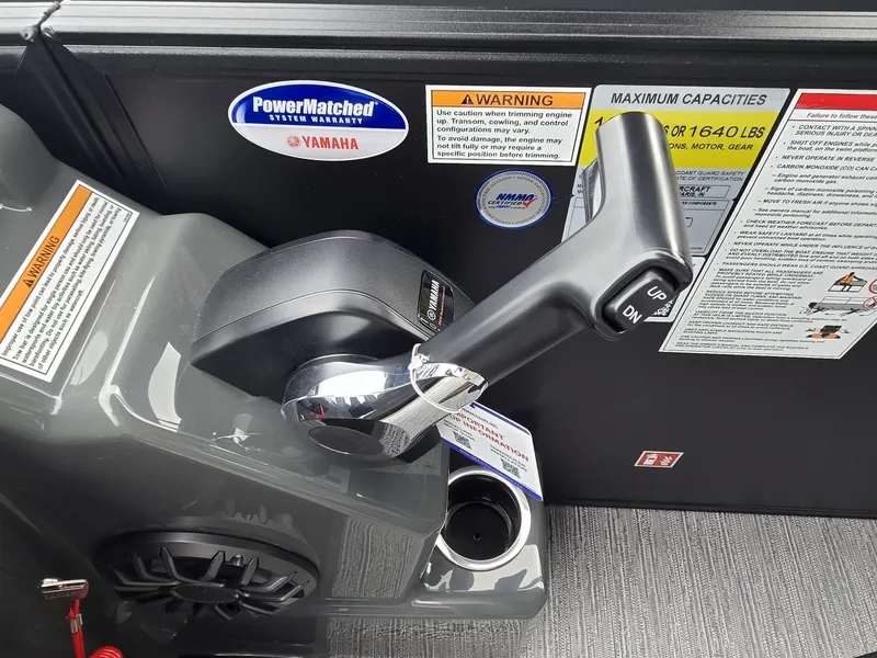 Slide: The Image of Close-up of a boat throttle lever with warning labels and Yamaha logo. - 18