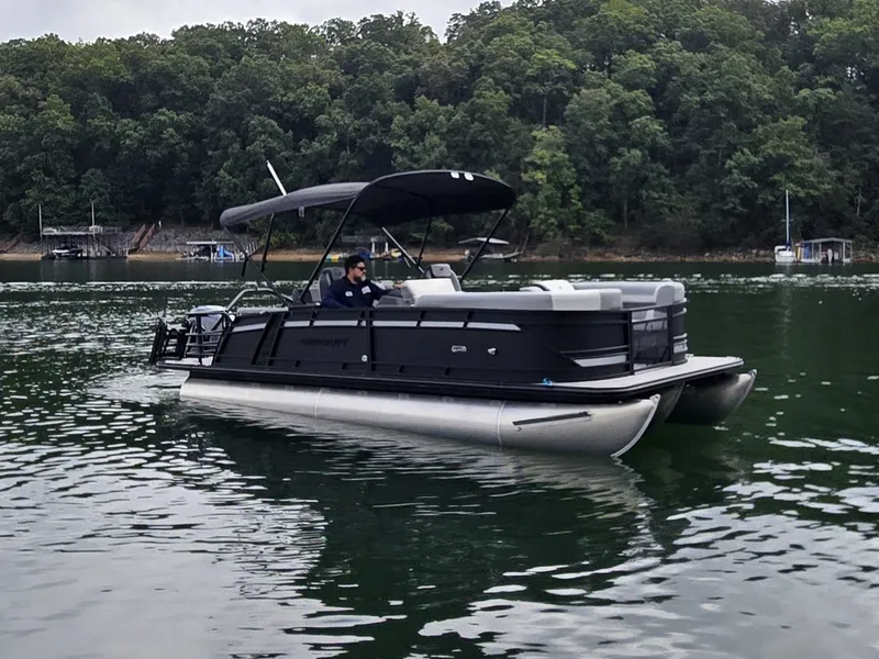 Slide: The Image of A 2027 Starcraft EXS 3 Q DH pontoon boat cruising on a calm lake. - 41