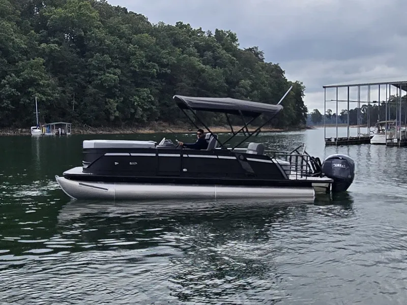 Slide: The Image of A 2027 Starcraft EXS 3 Q DH pontoon boat on a calm lake. - 33