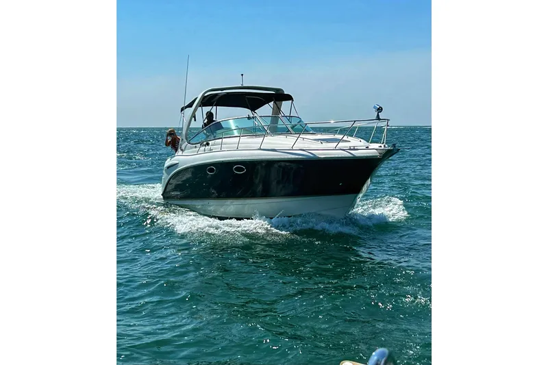 The Image of 2004 Chaparral Signature 310 cruising on open water under clear blue skies. - 0