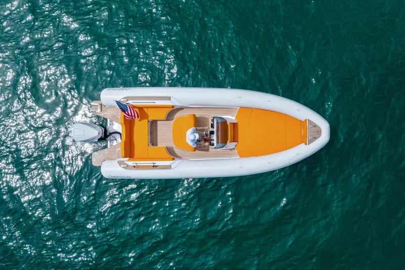 Slide: The Image of Aerial view of 2025 Antudo 23 boat with orange seating on blue water. - 3