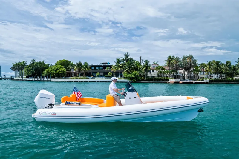The Image of 2025 Antudo 23 boat cruising on turquoise water near a tropical shoreline. - 0