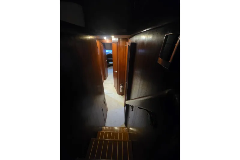Slide: The Image of Interior staircase of 1984 Bertram 54 Convertible yacht, leading to cabin area. - 101