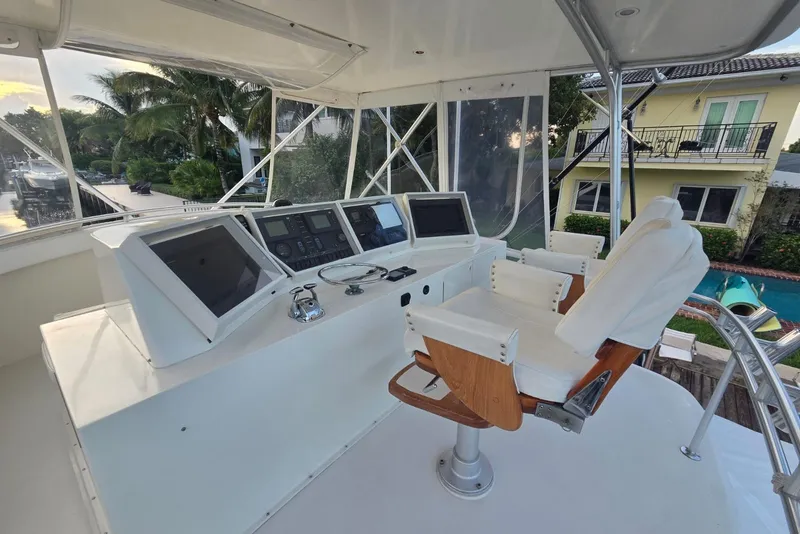 Slide: The Image of 1984 Bertram 54 Convertible yacht helm with modern navigation equipment and captain's chair. - 46