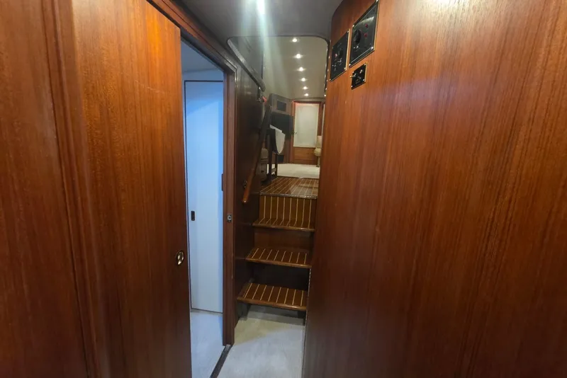 Slide: The Image of Interior of 1984 Bertram 54 Convertible yacht with wooden paneling and stairs. - 104