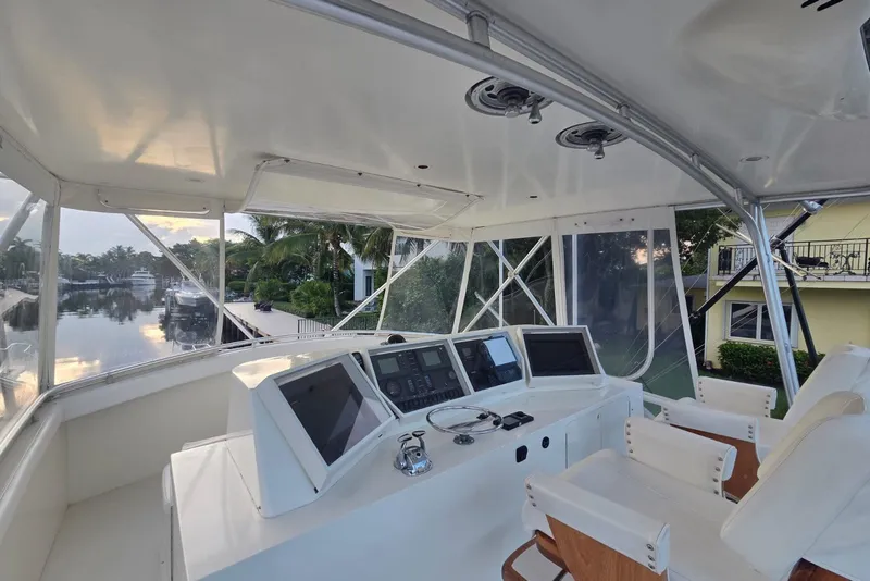 Slide: The Image of Cockpit view of a 1984 Bertram 54 Convertible yacht with modern navigation equipment. - 47