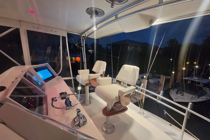Slide: The Image of Interior view of a 1984 Bertram 54 Convertible yacht cockpit at night. - 80