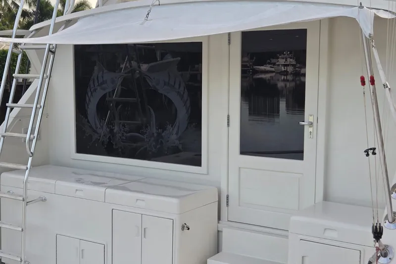 Slide: The Image of 1984 Bertram 54 Convertible yacht with ladder and storage compartments. - 26