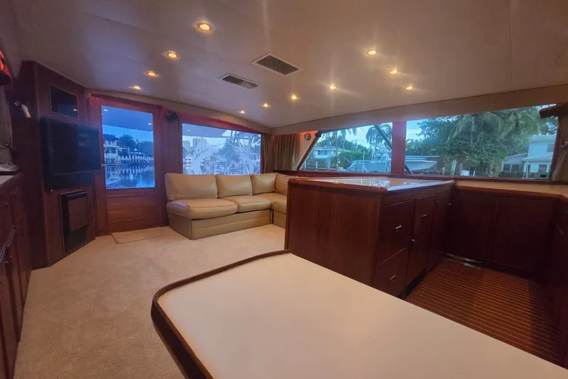 Slide: The Image of Luxurious interior of a 1984 Bertram 54 Convertible yacht with plush seating and wood cabinetry. - 40