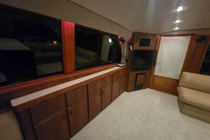 Slide: The Image of Interior of 1984 Bertram 54 Convertible yacht with wood cabinetry and modern lighting. - 75