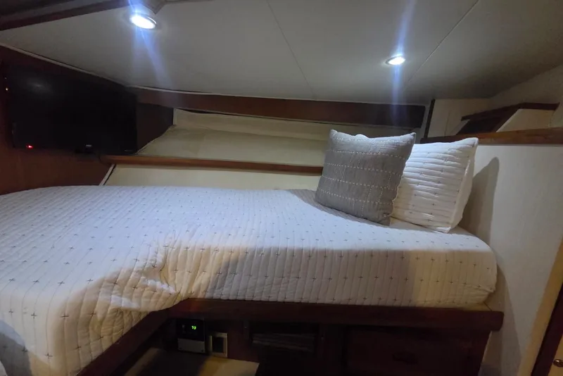 Slide: The Image of Cozy bedroom interior of 1984 Bertram 54 Convertible yacht with modern lighting. - 76