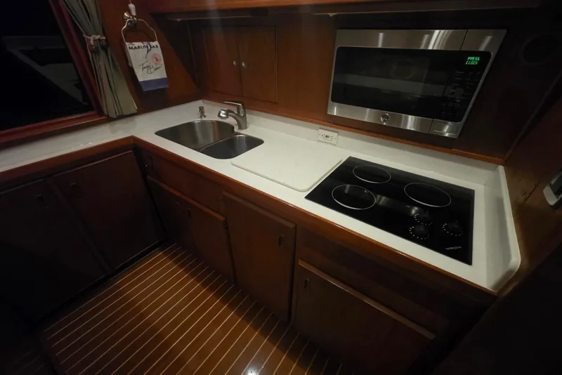 Slide: The Image of Galley kitchen in 1984 Bertram 54 Convertible yacht with stove, sink, and microwave. - 58