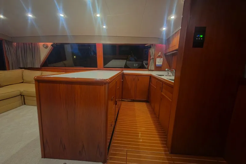 Slide: The Image of Interior of 1984 Bertram 54 Convertible yacht with wooden cabinetry and modern lighting. - 78