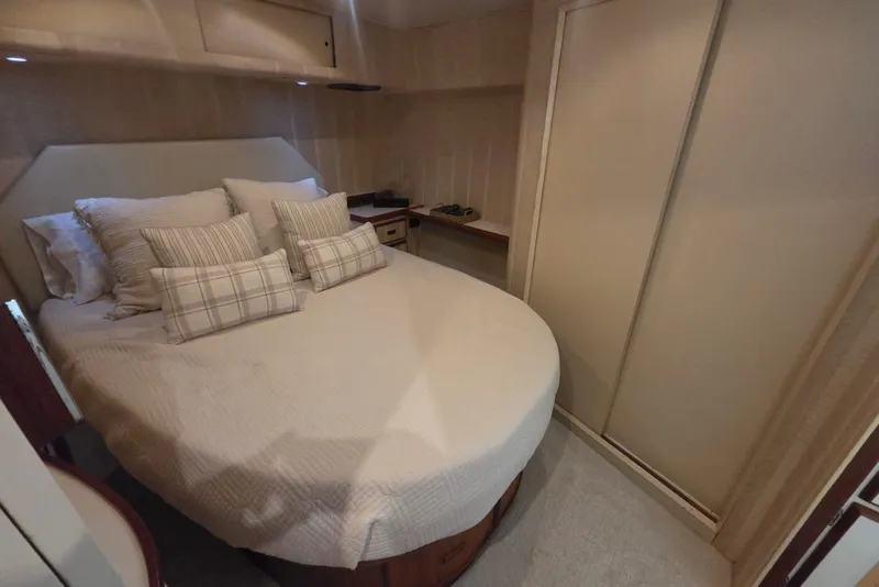 Slide: The Image of Cozy bedroom interior of 1984 Bertram 54 Convertible yacht with plush bedding and storage. - 69