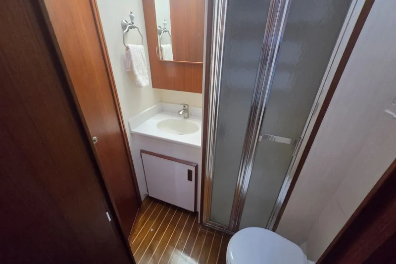 Slide: The Image of Bathroom interior of 1984 Bertram 54 Convertible yacht with shower and sink. - 110