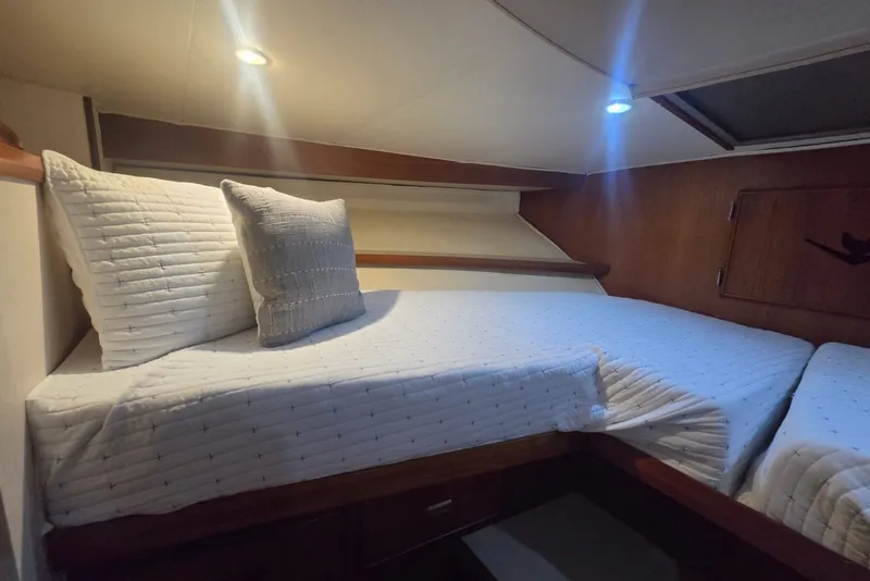 Slide: The Image of Cozy cabin interior of 1984 Bertram 54 Convertible yacht with comfortable bedding. - 68