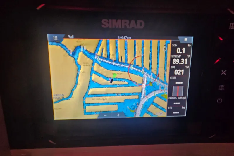 Slide: The Image of Simrad marine GPS display on a 1984 Bertram 54 Convertible boat, showing navigation map. - 91