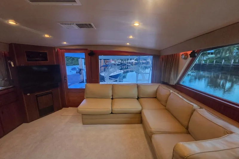 Slide: The Image of Luxurious interior of a 1984 Bertram 54 Convertible yacht with beige seating and large windows. - 35