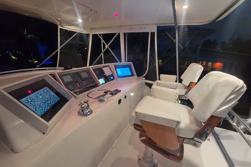 Slide: The Image of Interior cockpit of a 1984 Bertram 54 Convertible yacht with modern navigation equipment. - 81