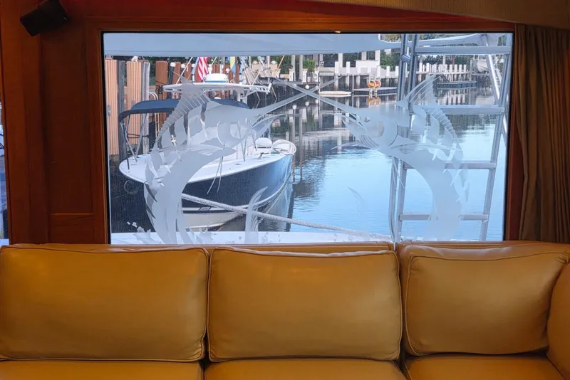 Slide: The Image of Interior view of a 1984 Bertram 54 Convertible yacht with etched marlin window design. - 36
