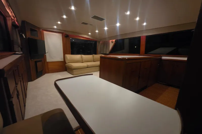 Slide: The Image of Luxurious interior of a 1984 Bertram 54 Convertible yacht with elegant wood finishes. - 94