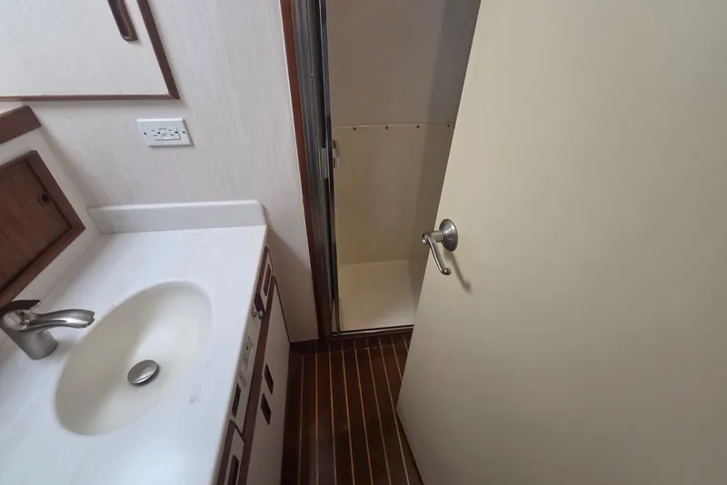 Slide: The Image of Bathroom interior of 1984 Bertram 54 Convertible yacht, featuring sink and shower area. - 102